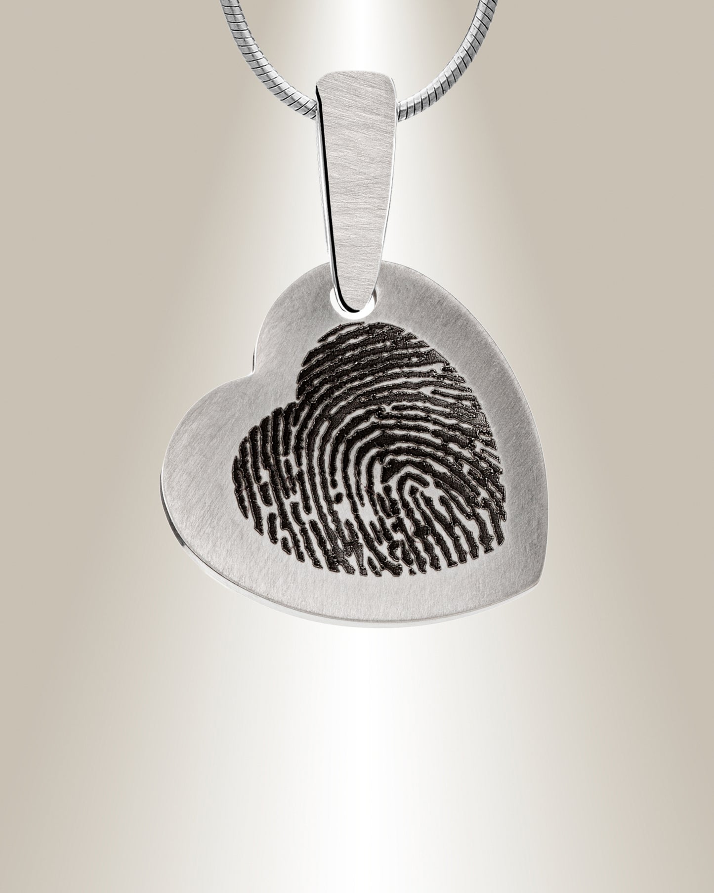 A stainless steel fingerprint pendant with a brushed appearance and an engraved fingerprint image in the center, attached to a chain.