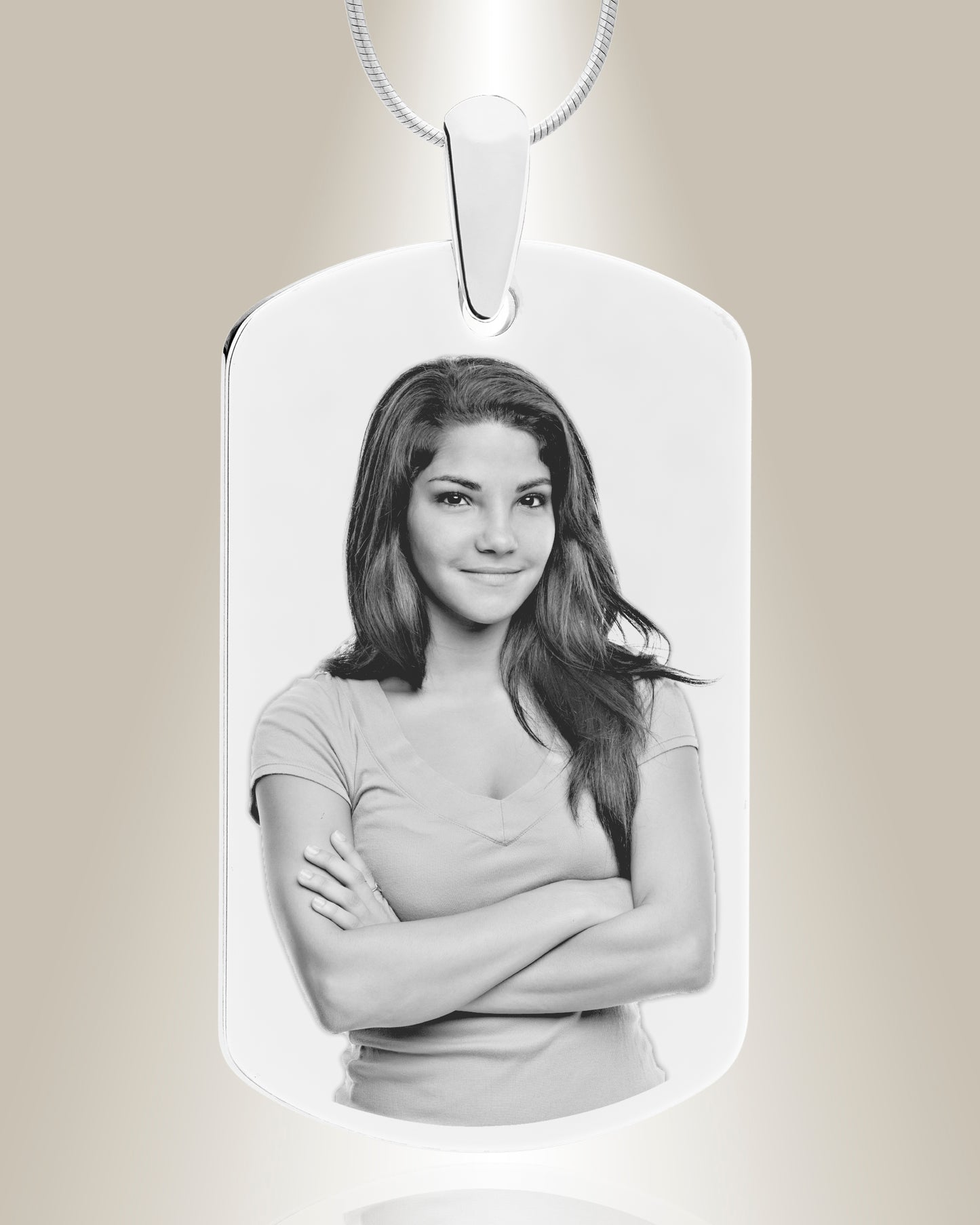 A stainless steel dog tag photo pendant with an engraved black and white image of a woman.