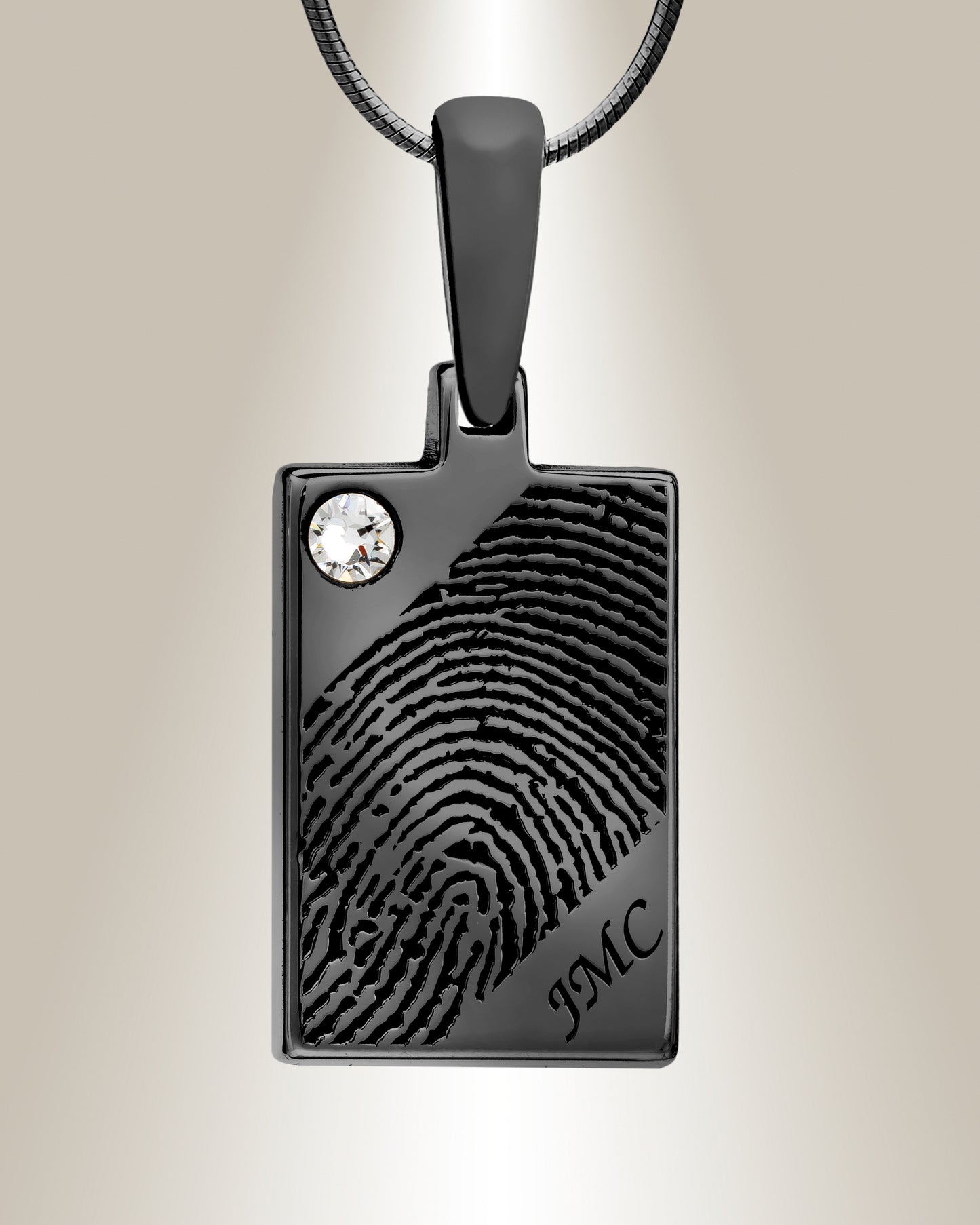 A black gemstone rectangle fingerprint pendant with an accent gemstone at the top left corner and initials engraved on the lower right corner, displayed against a white background.