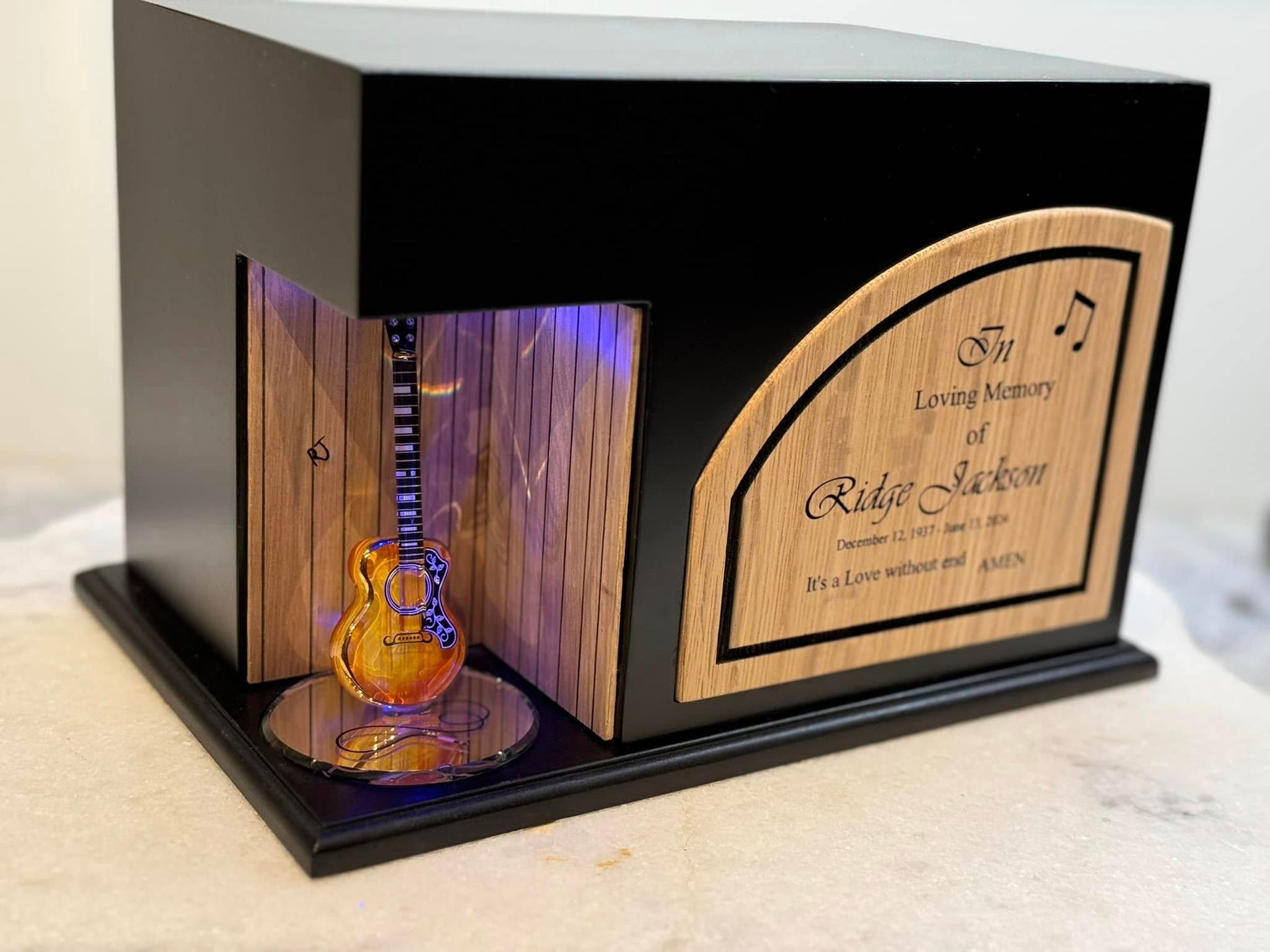 front view of 2 tone wood urn with lighted guitar custom designed by Stinson Urn Company for music lovers
