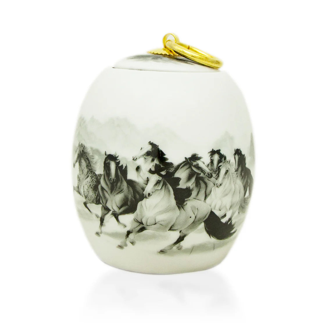 A ceramic urn with hand-painted black and white horses on it, finished in eggshell white, with a gold-colored keychain attached to the lid.