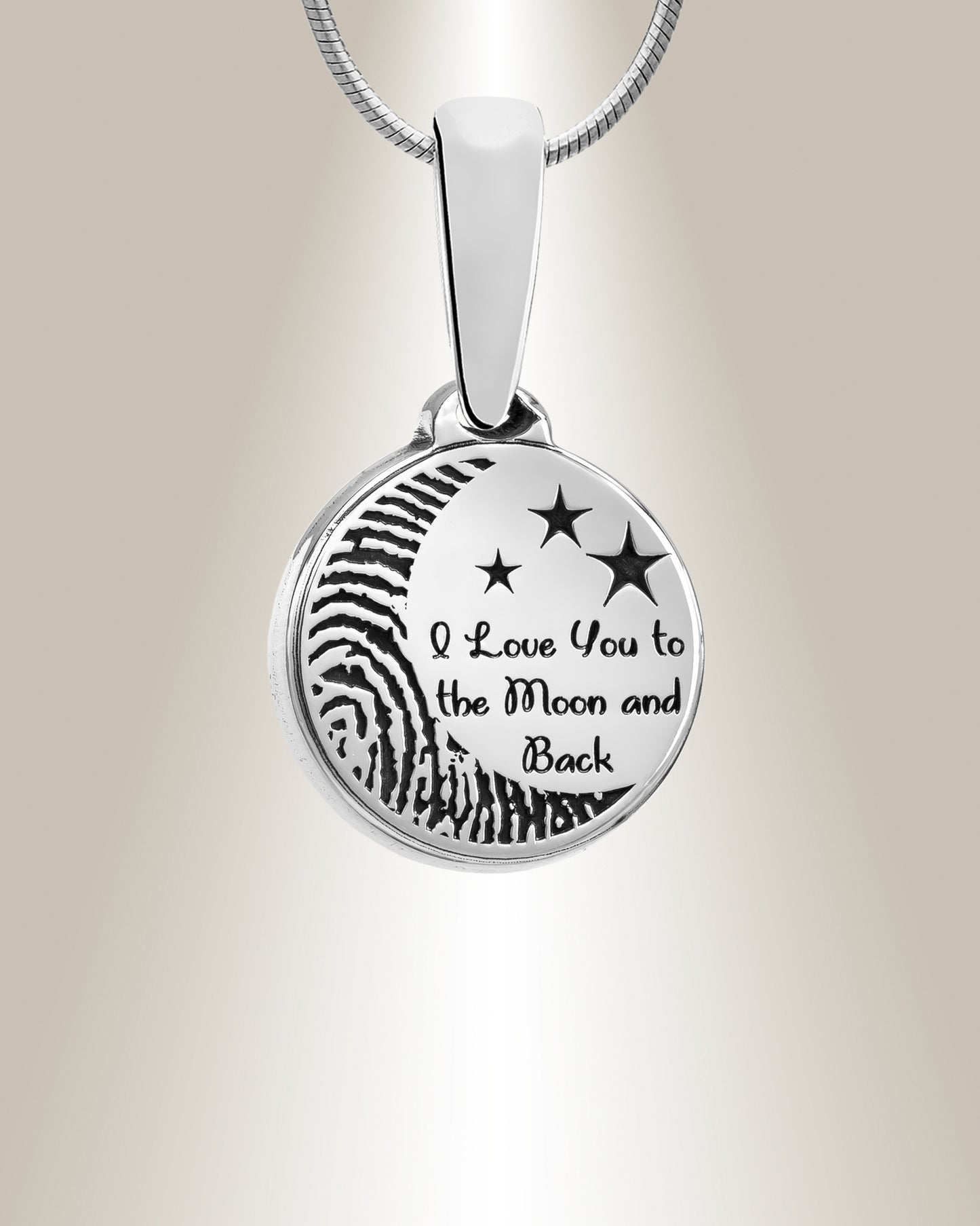 A sterling silver round pendant with an engraved fingerprint shape and the phrase 'I love you to the moon and back', accompanied by a matching 20" chain.