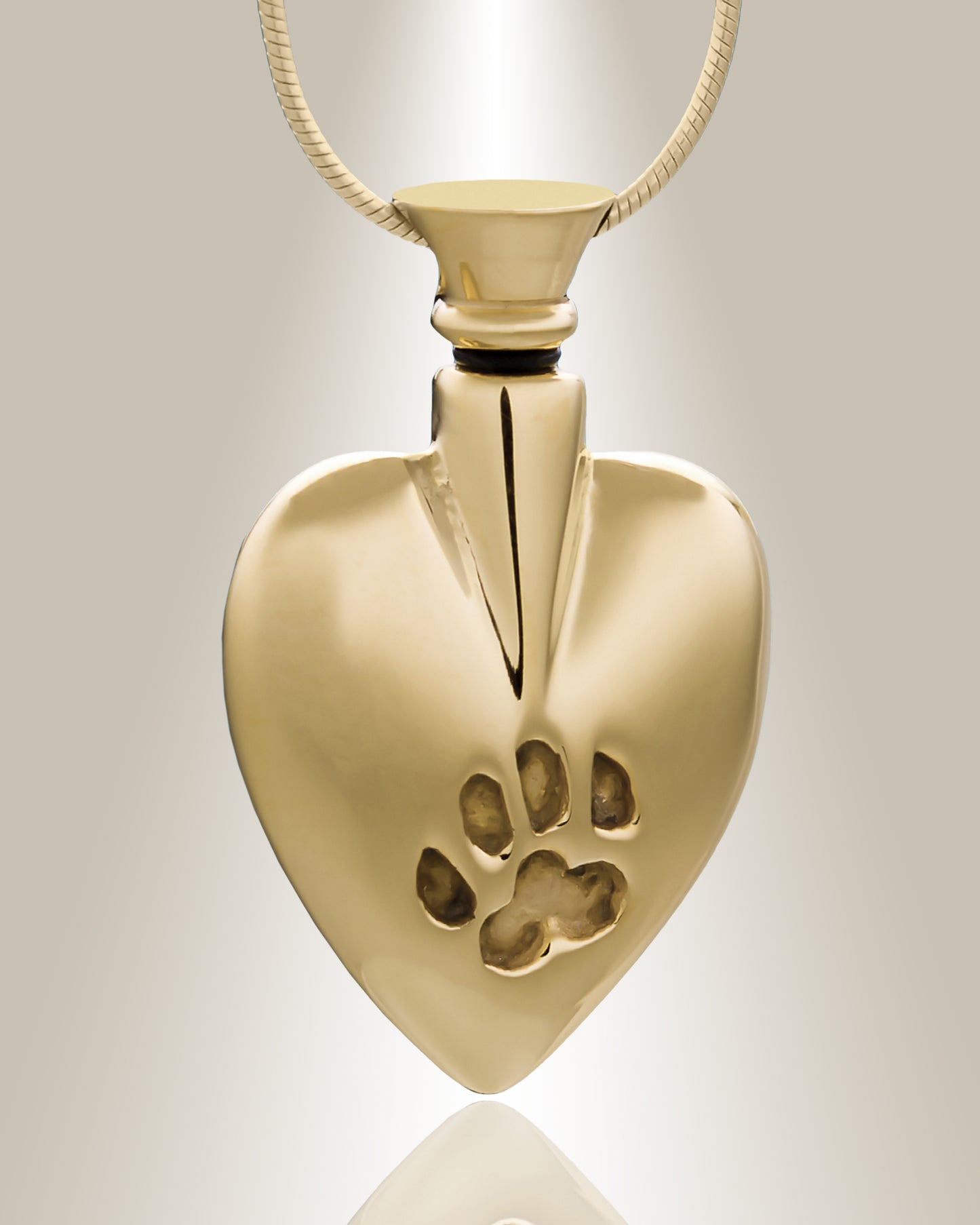A heart-shaped sterling silver cremation pendant with a small paw print design on the front, included with a matching 20-inch chain.