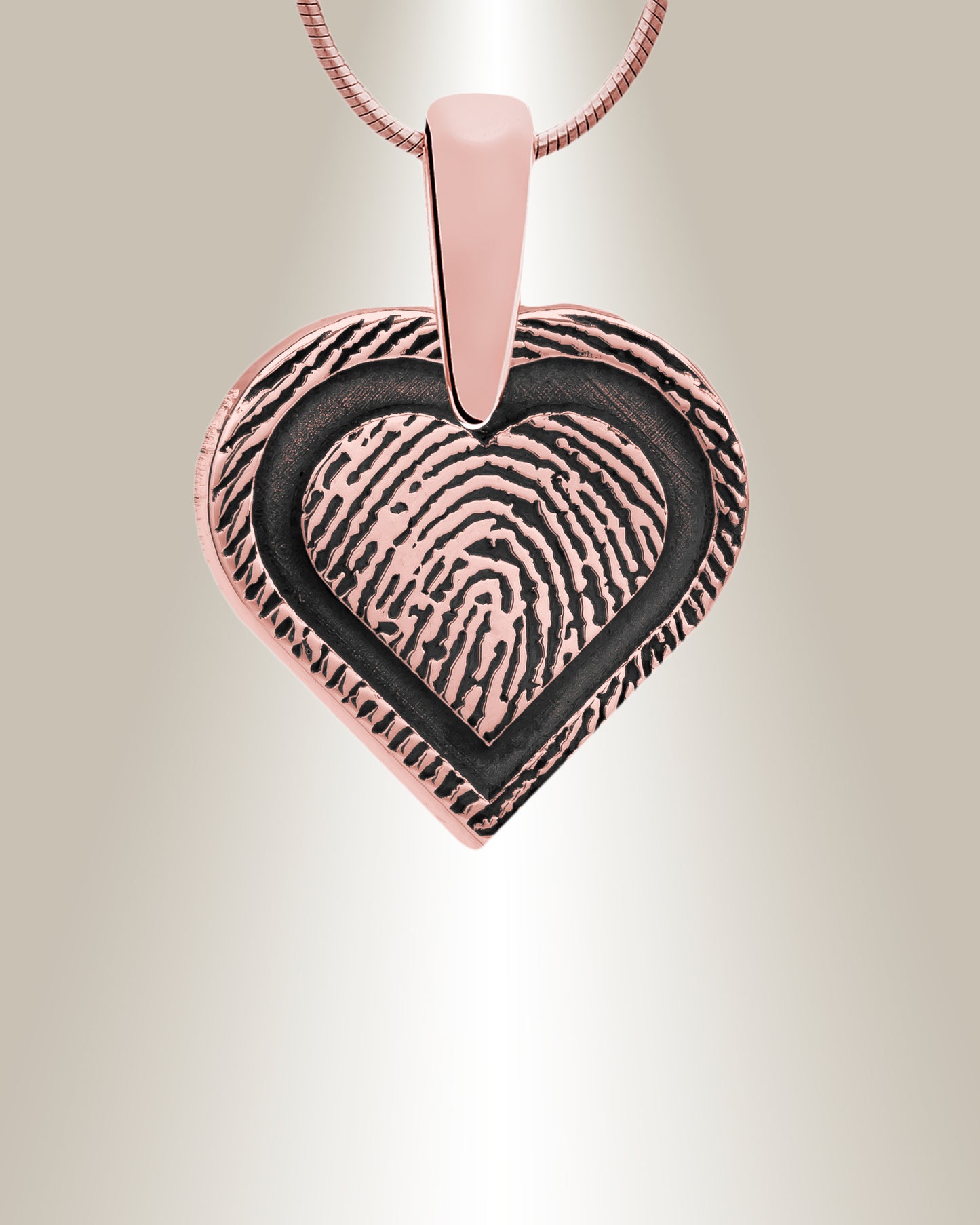 A sterling silver heart-shaped pendant with a fingerprint engraving and a space for personalization on the bottom right. It includes a matching 20" chain.