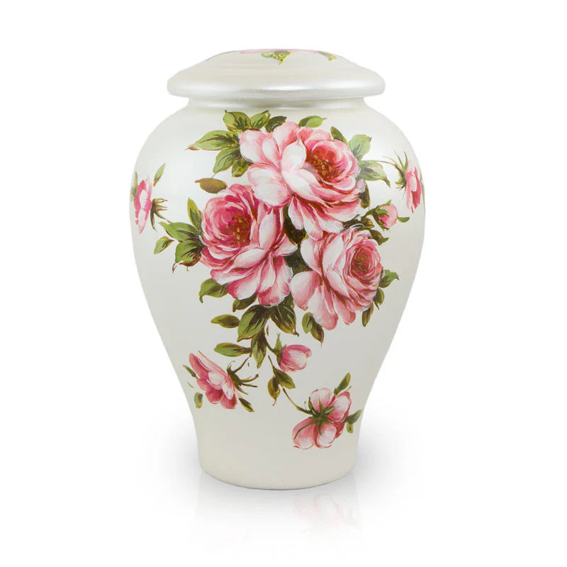 A white ceramic cremation urn with a floral rose design.