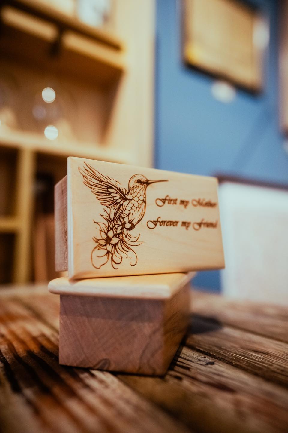 small keepsake urn showing hummingbird on lid with name engraved.