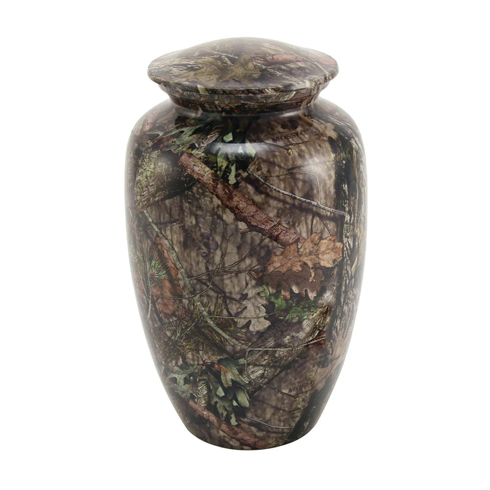 Cremation urn with a leafy camouflage design, predominantly green and brown in color, with a threaded lid on top.