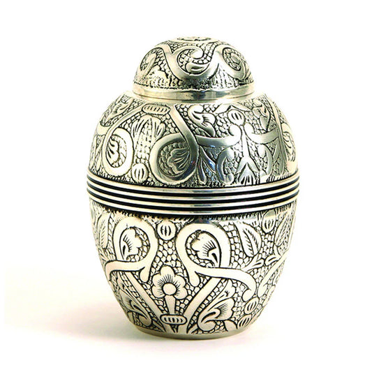 A nickel-plated brass pet urn with hand-engraved floral design.