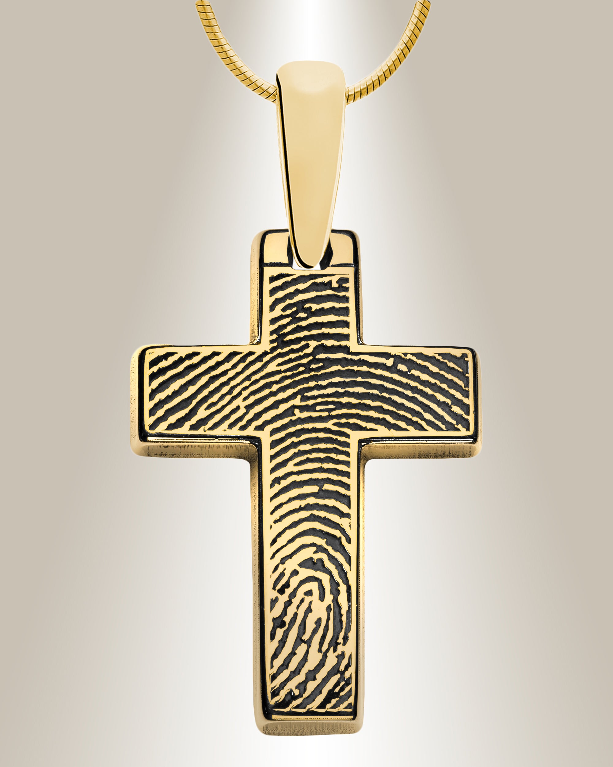 A sterling silver cross pendant with a fingerprint laser engraved on it, displayed with a 20