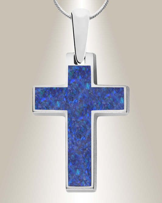 A blue and white marbled cross-shaped pendant necklace with a resin center mixed with cremated ashes, set in a silver-colored frame, displayed against a neutral background.