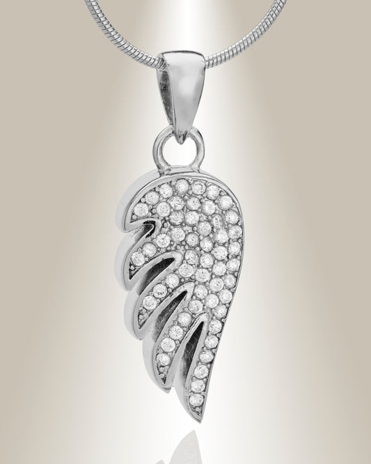 Angel wing shaped cremation pendant made of sterling silver with gemstone accents, displayed with an included matching 20" chain.