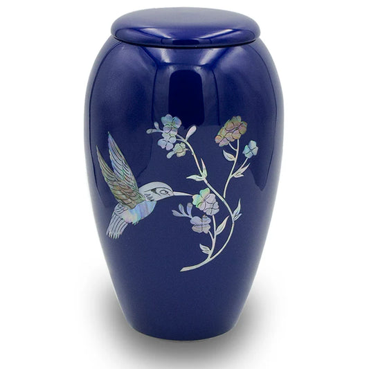 A navy blue urn with a hand-crafted hummingbird and flowers design on the side.