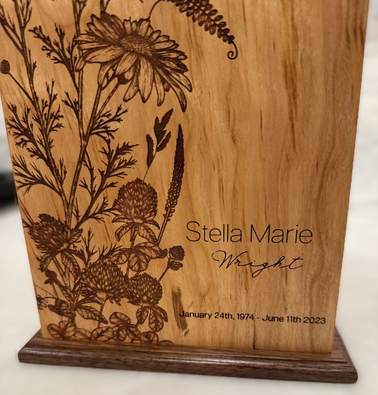 Flowers engraved on wood urn: St. Mary's County