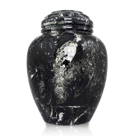 A black and white marble urn with a unique pattern, hand-carved from one solid piece of stone.