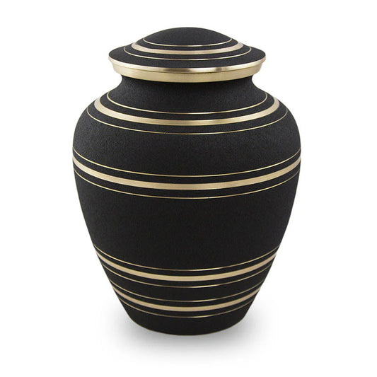 A matte black bronze urn with elegant bronze stripes and a lid.