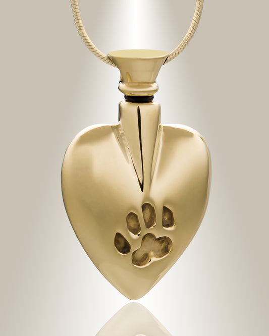 A heart-shaped sterling silver cremation pendant with a small paw print design on the front, included with a matching 20-inch chain.