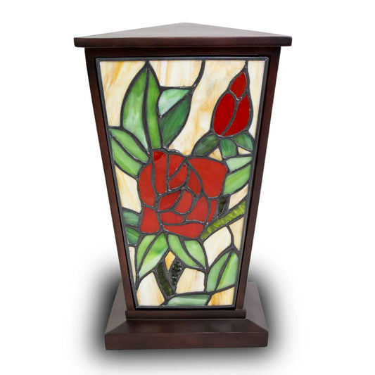 A handcrafted stained glass urn with a vibrant red rose design on one side, set within a resin frame. The urn is completely opaque with no visibility into the interior.