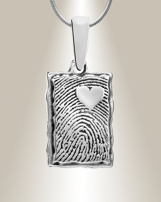 A sterling silver pendant with a rectangle shape featuring a heart-shaped fingerprint detail at the top right corner, displayed against a neutral background.