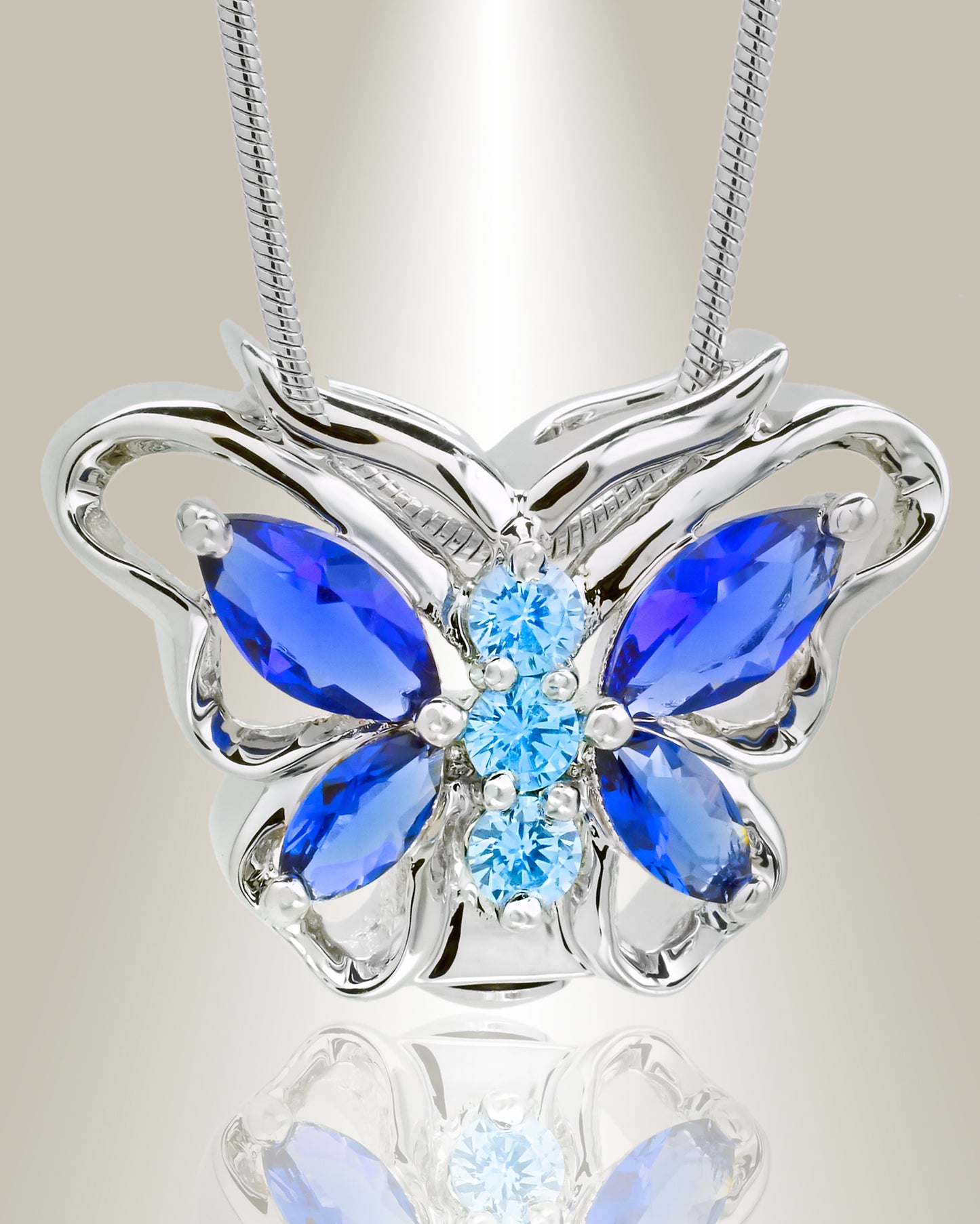 A silver butterfly-shaped cremation pendant with blue accent stones on a chain.