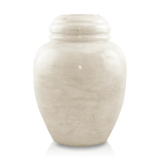 A hand-carved white marble cremation urn with a smooth finish.