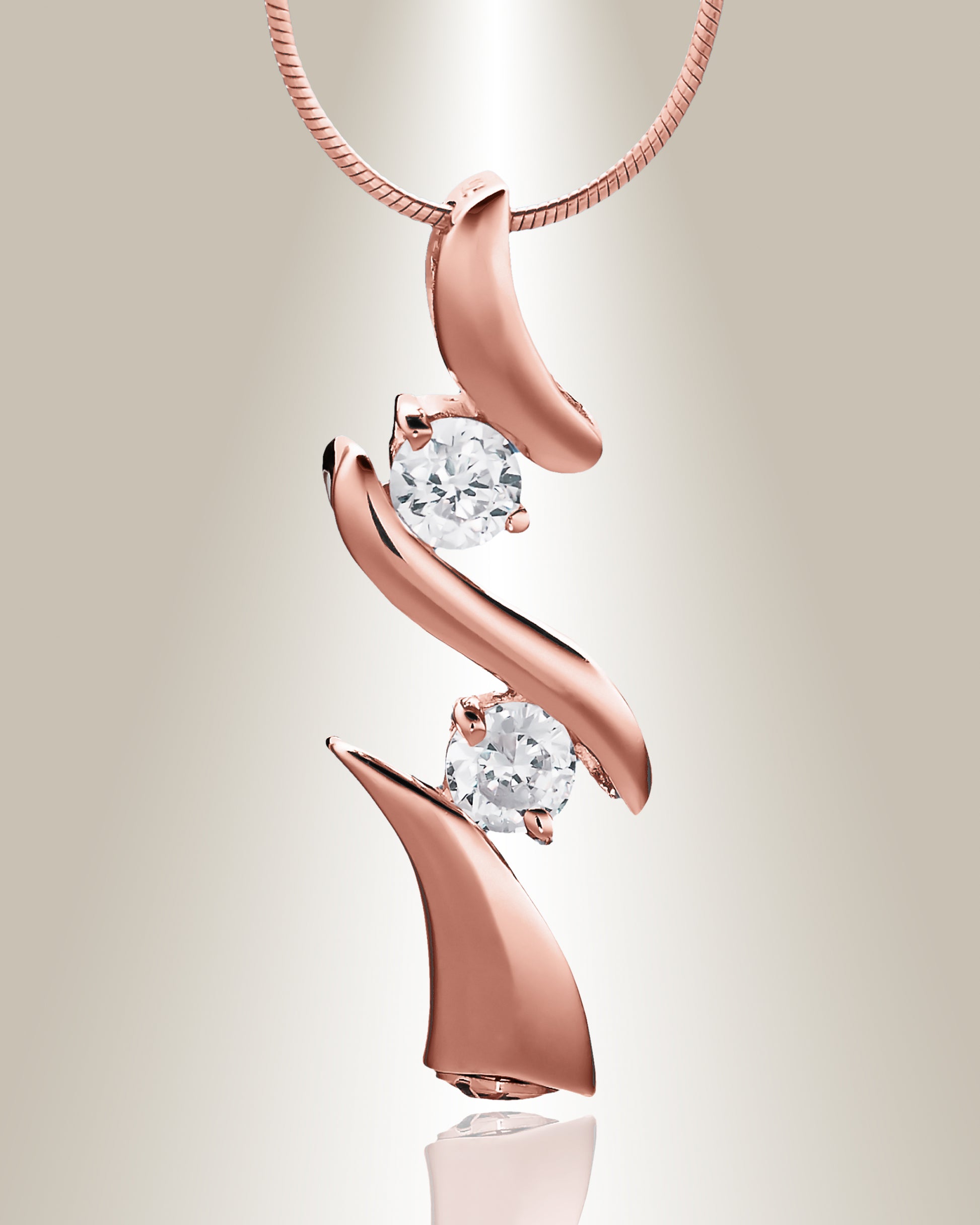 A rose gold trinity cremation pendant with two clear gemstone accents on a chain, designed to hold cremated ashes.
