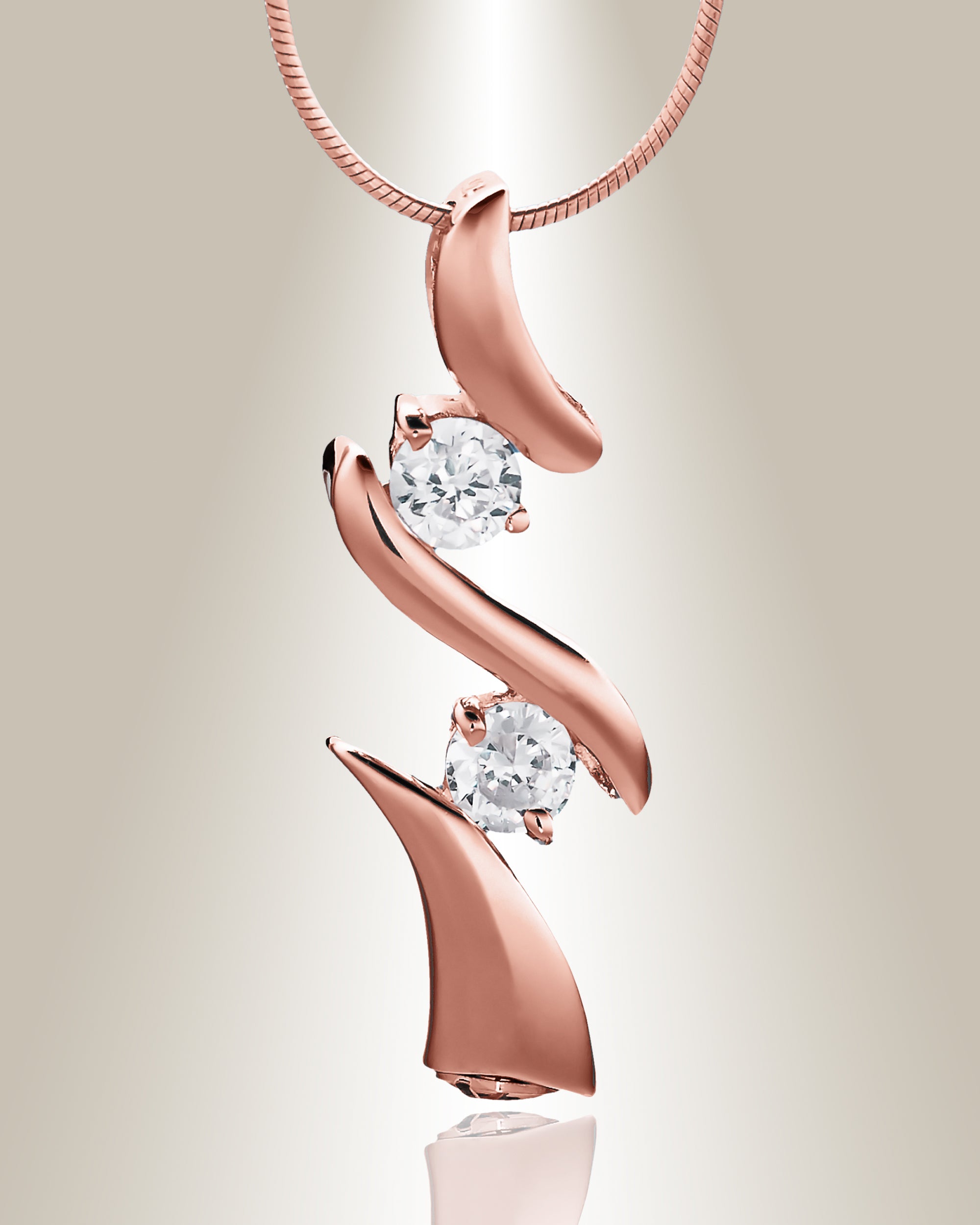 A rose gold trinity cremation pendant with two clear gemstone accents on a chain, designed to hold cremated ashes.