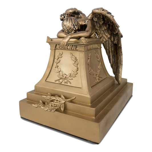 A bronze cremation urn with a detailed angel figure on top, made from cold-cast resin with a felt bottom.