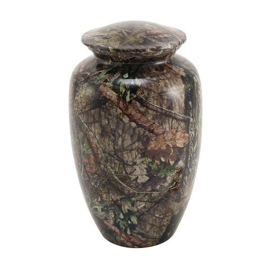 Cremation urn with a leafy camouflage design, predominantly green and brown in color, with a threaded lid on top.